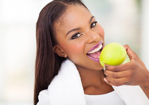 A girl eating a fruit