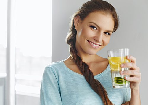 A girl holding a glass of water